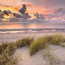 Sunset View from dune top over North Sea and Canal in Zeeland, Netherlands